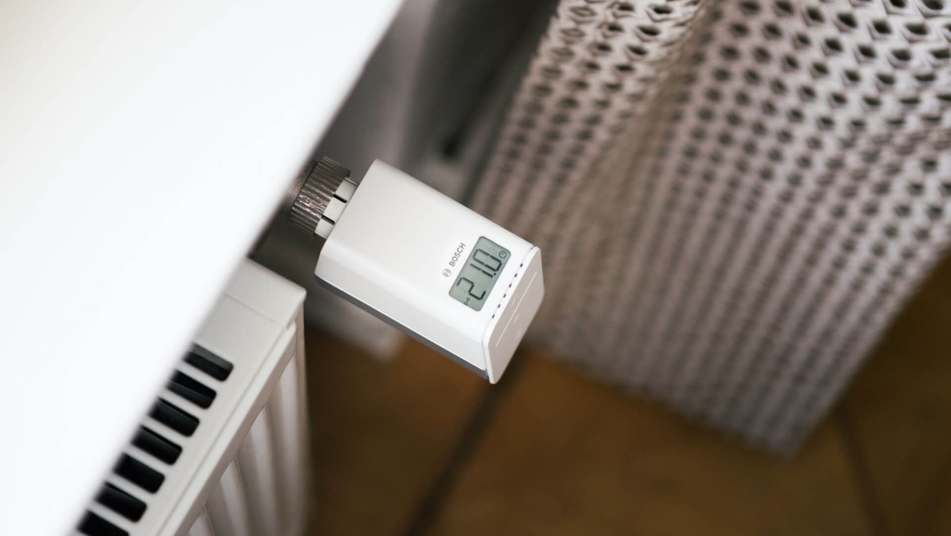 Close up of smart home thermostat on side of a household radiator