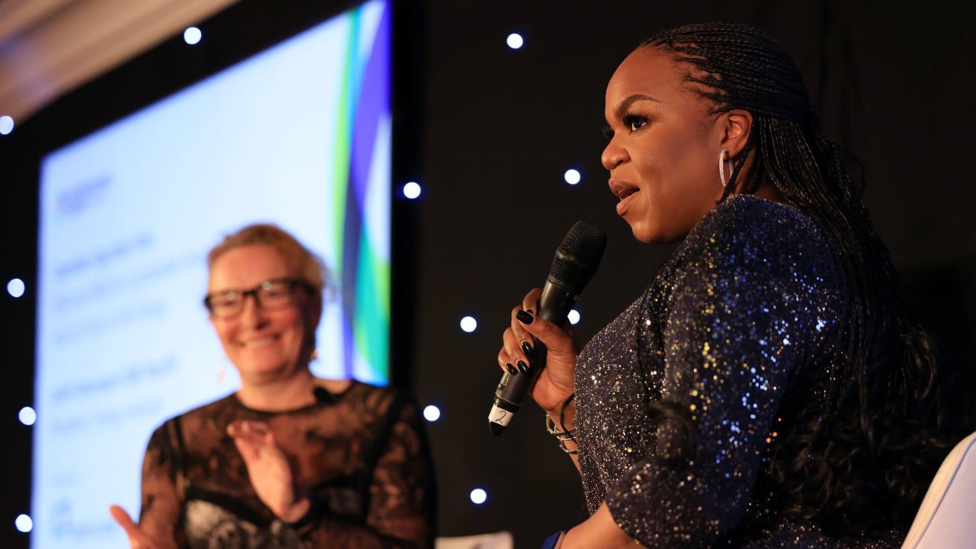 Damilola Ogunbiyi talking from stage at International Energy Week Dinner