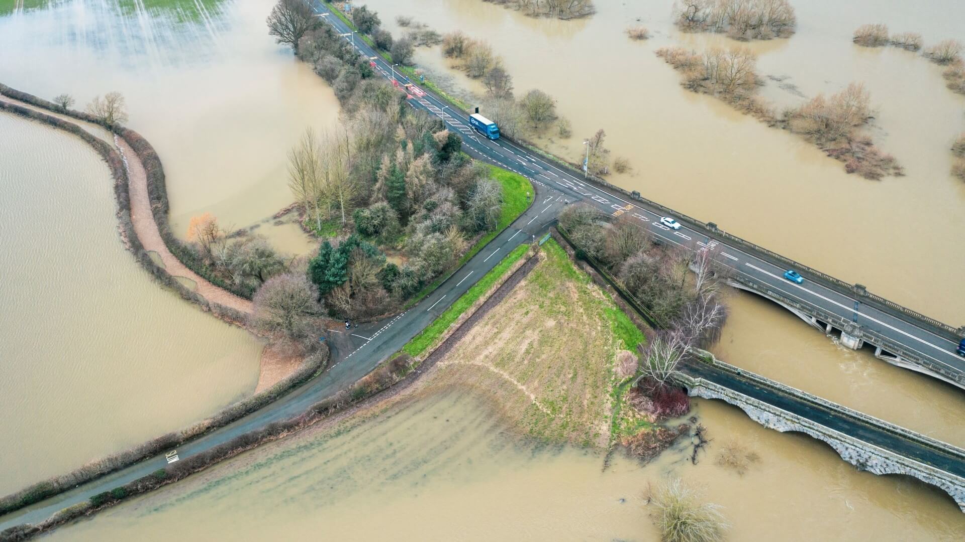 Aerial overview of flooded fields adjacent to road network