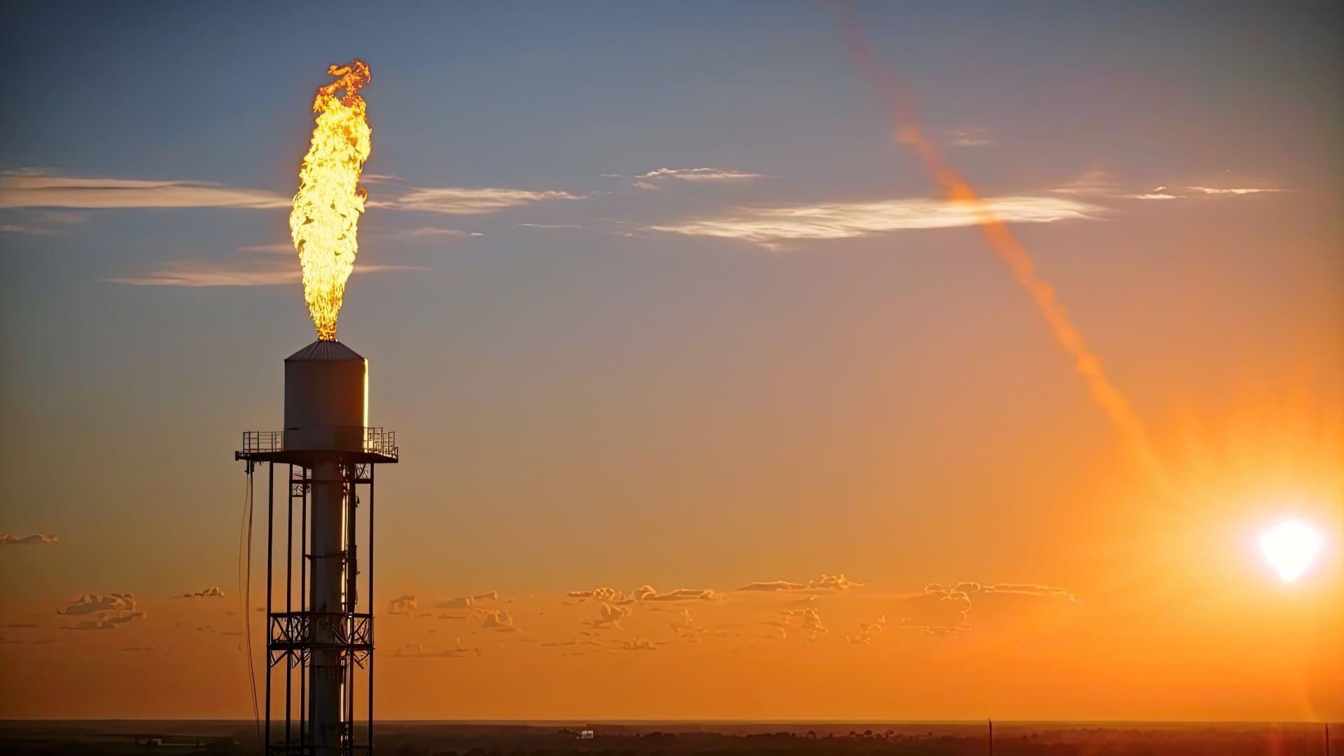 Close up shot of gas flaring against sunset sky