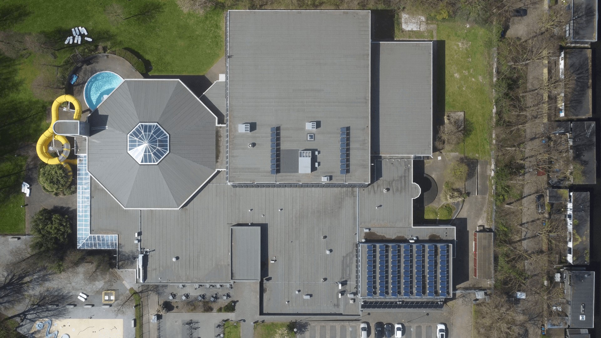 Aerial view over public swimming pool in Utrecht with solar panels on roof