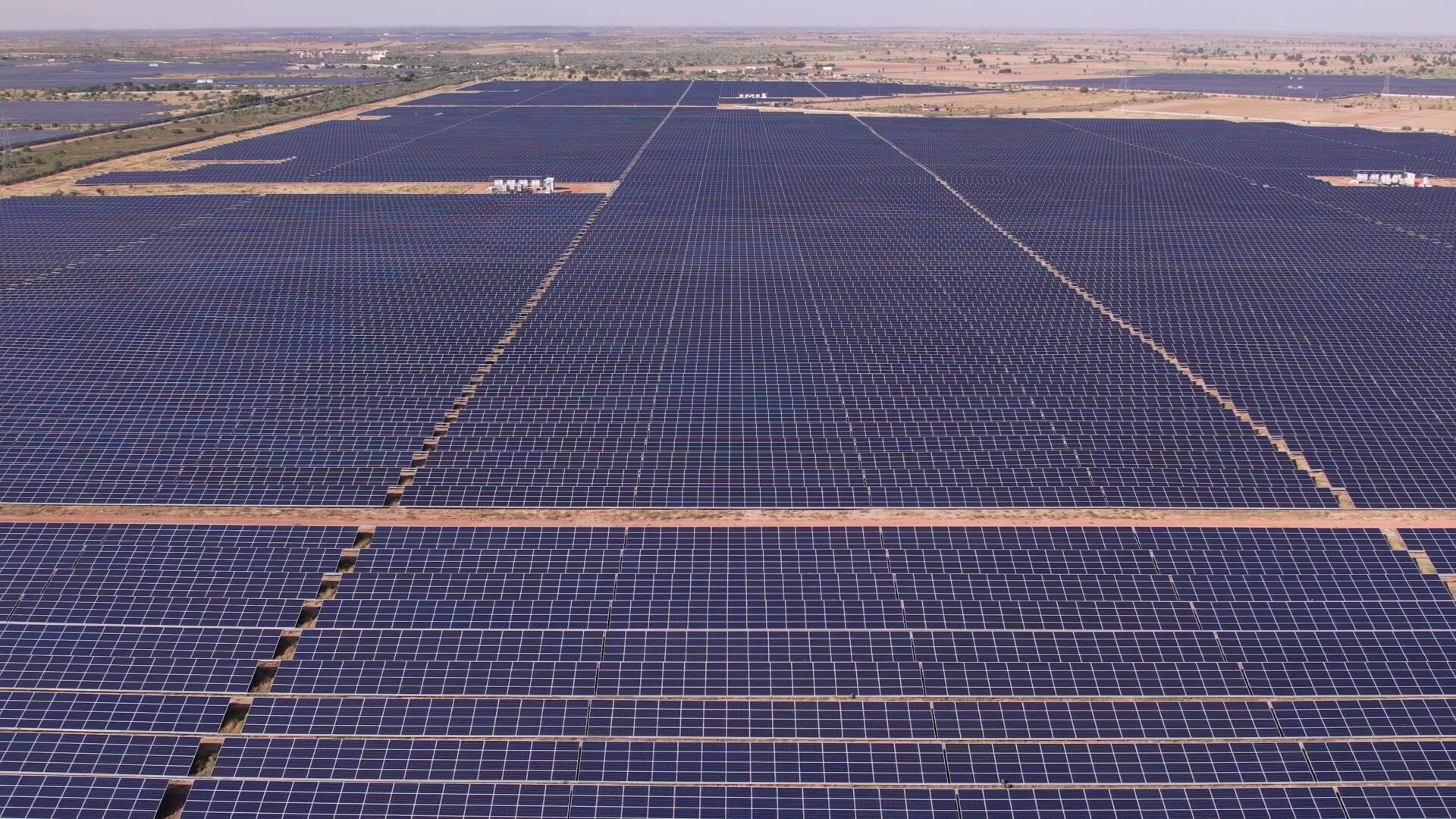 Aerial overview of millions of solar panels spread far across the desert