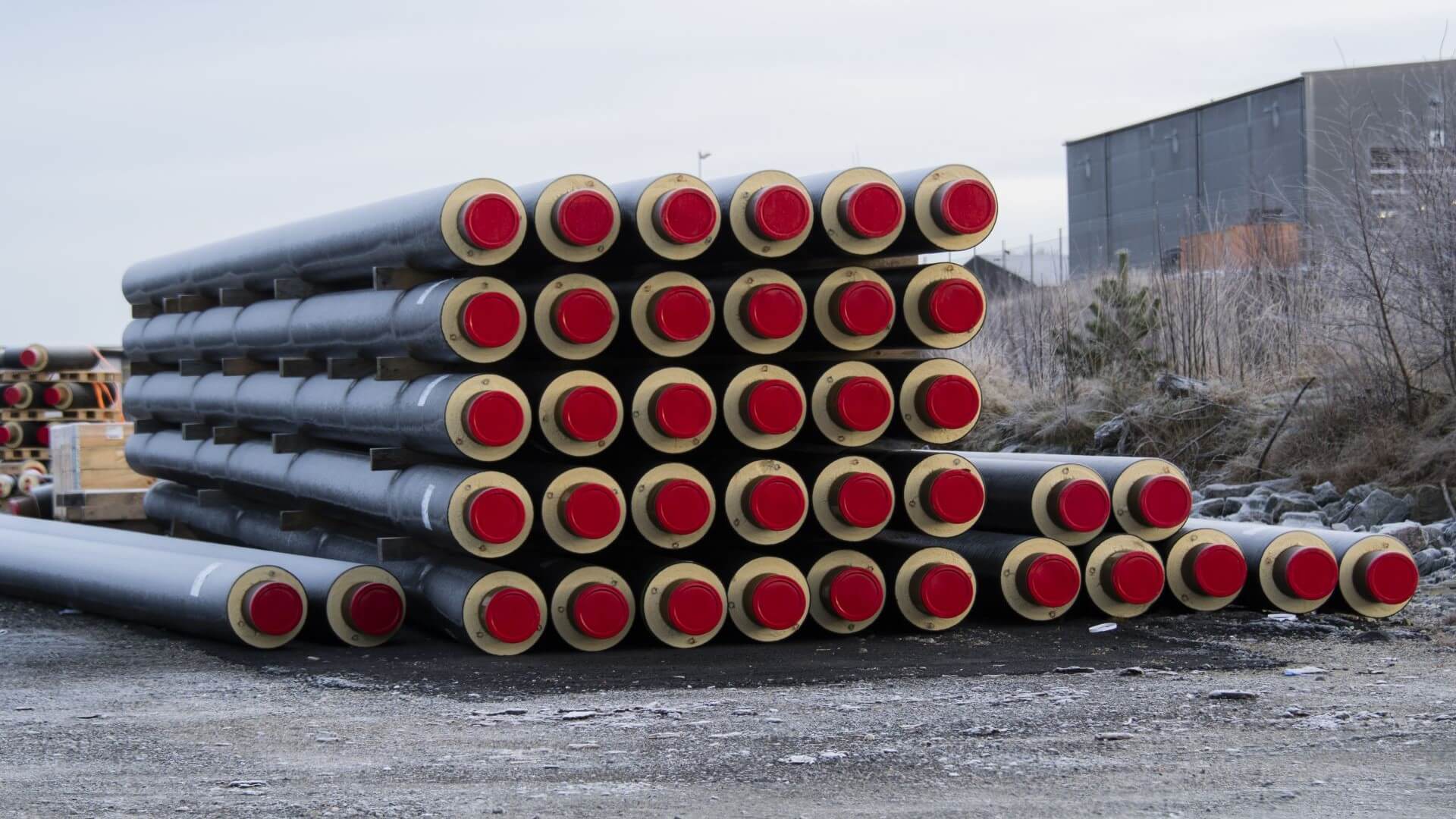 Thermal insulated pipes stacked in a pile one on top of the other