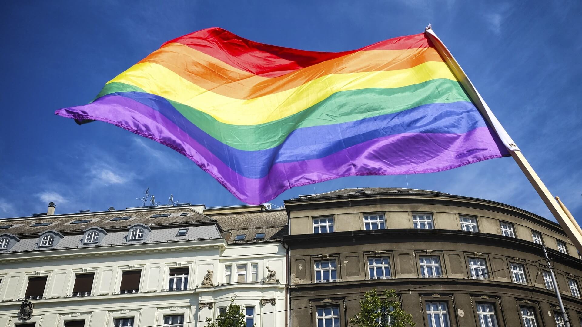 Pride Flag flying in front of building 