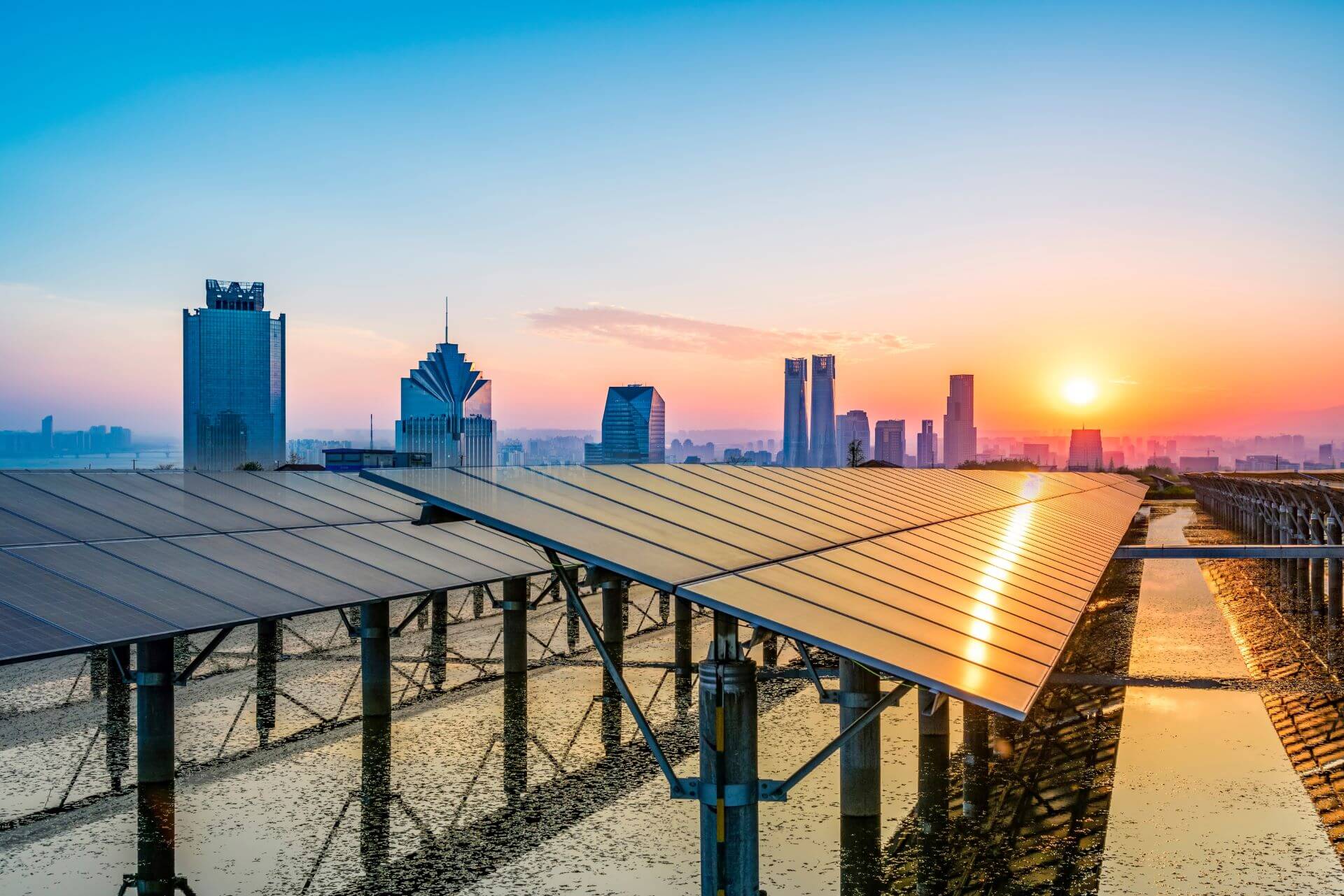 Roof top solar panels with Shanghai sky line in the background at sunset