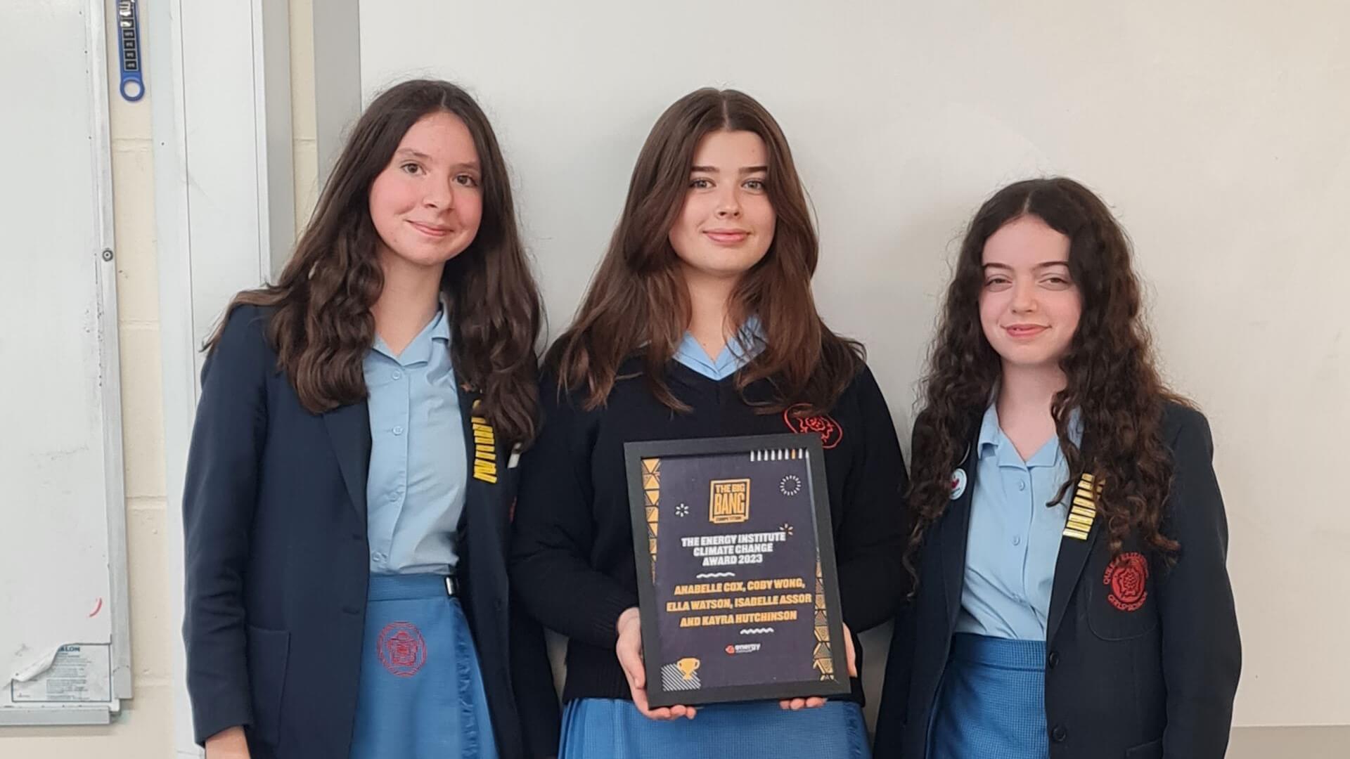 Photo of three girls holding certificate in recognition of winning the 2023 Energy Institute Climate Change Award