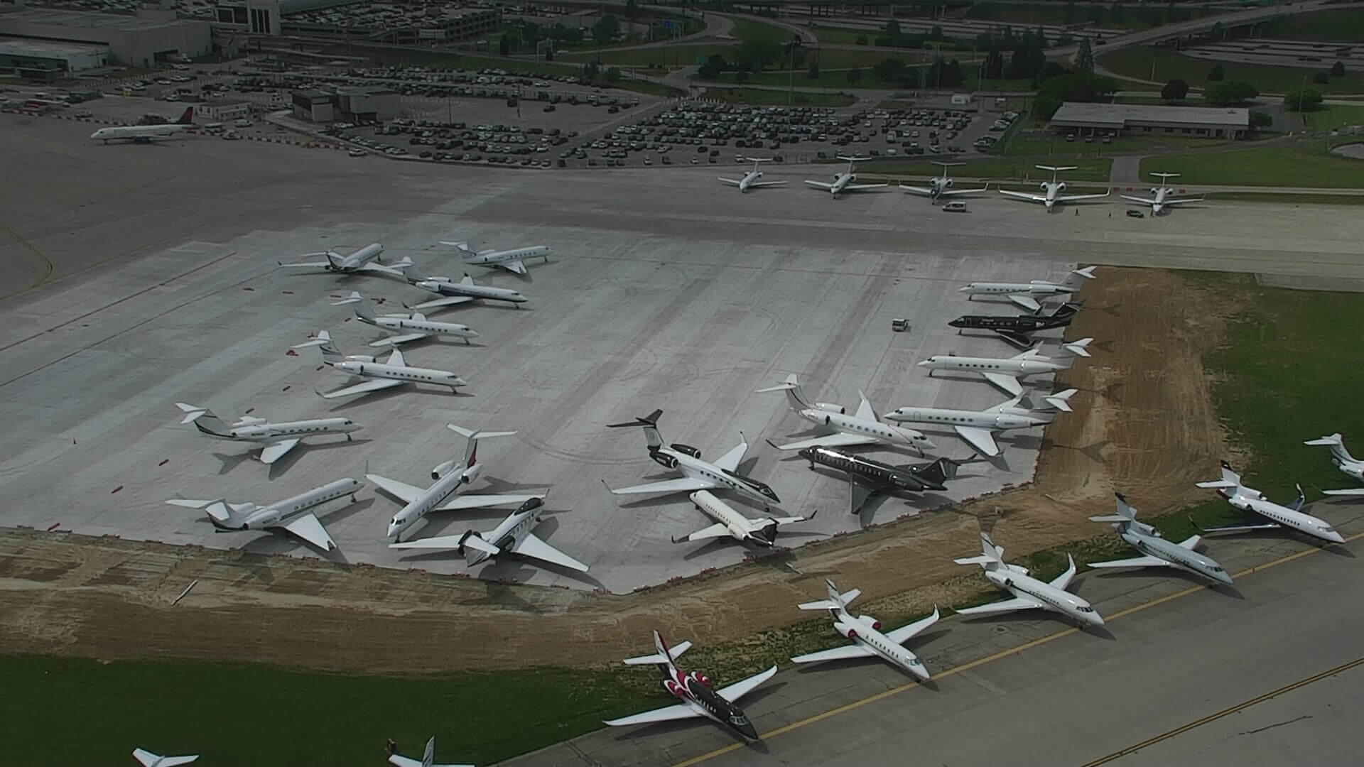 Aircraft parking on new ramp overtop geothermal wellfield