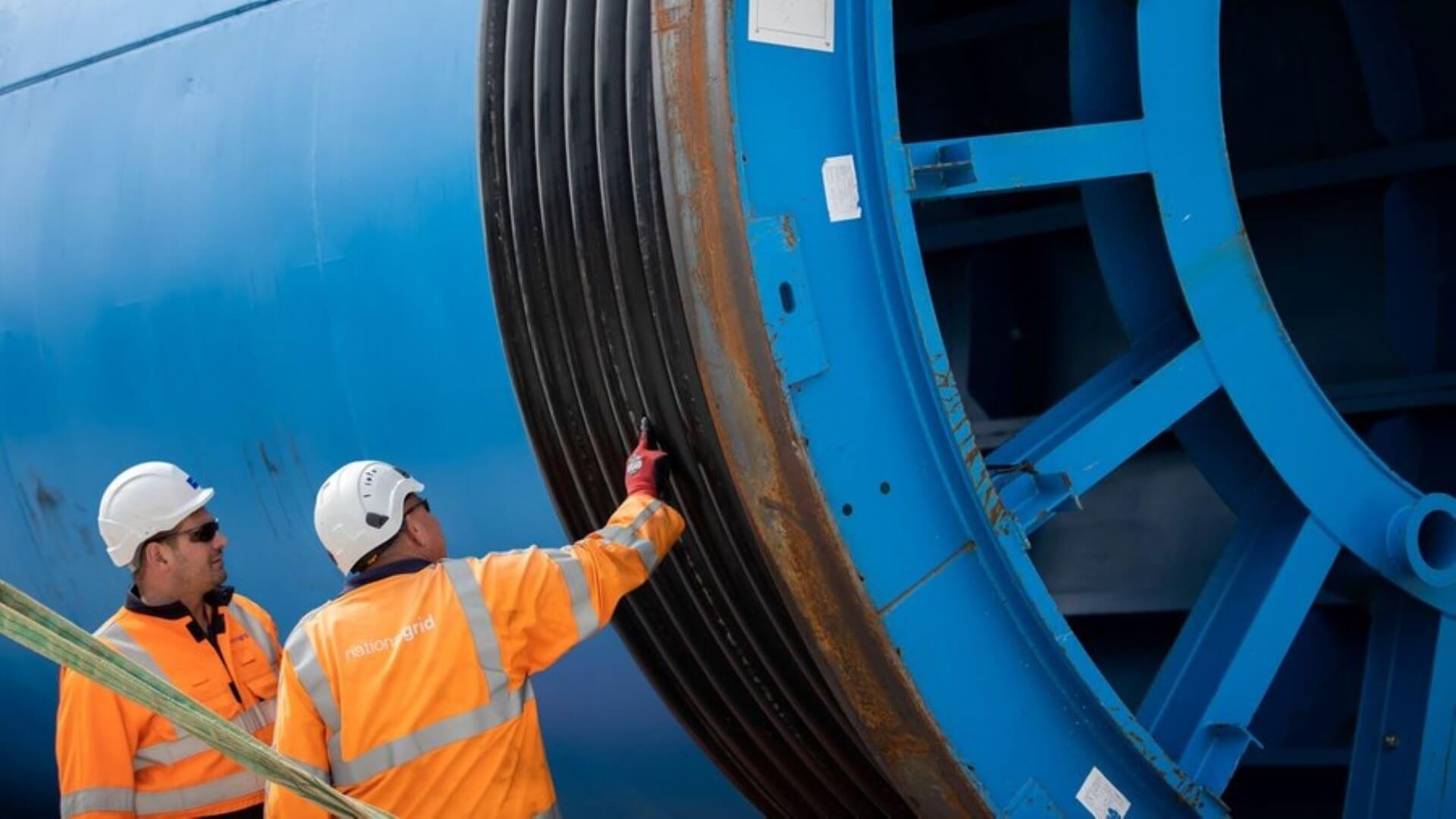 Two engineers inspecting cable drum