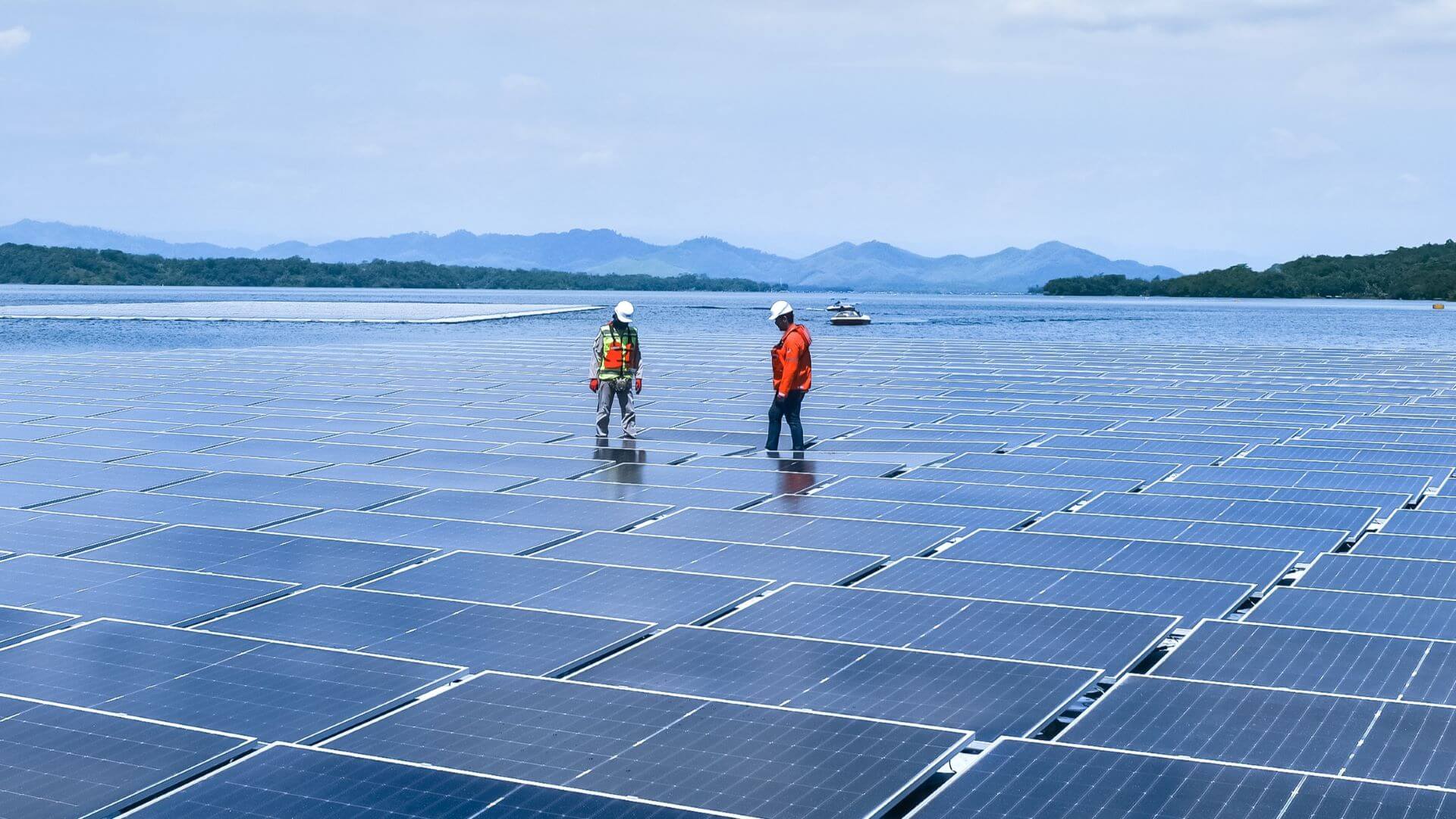 Two engineers standing on the Cirata floating solar platform, Indonesia