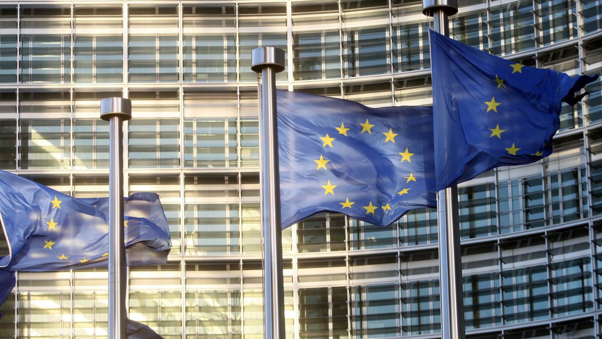 European Commission flags flying outside building