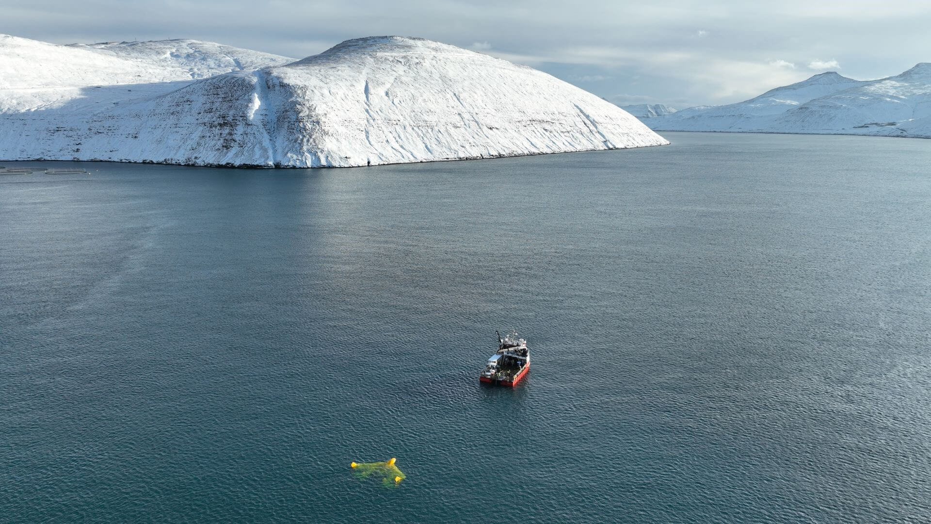 Boat pulling kite device with snowy mountains in the background