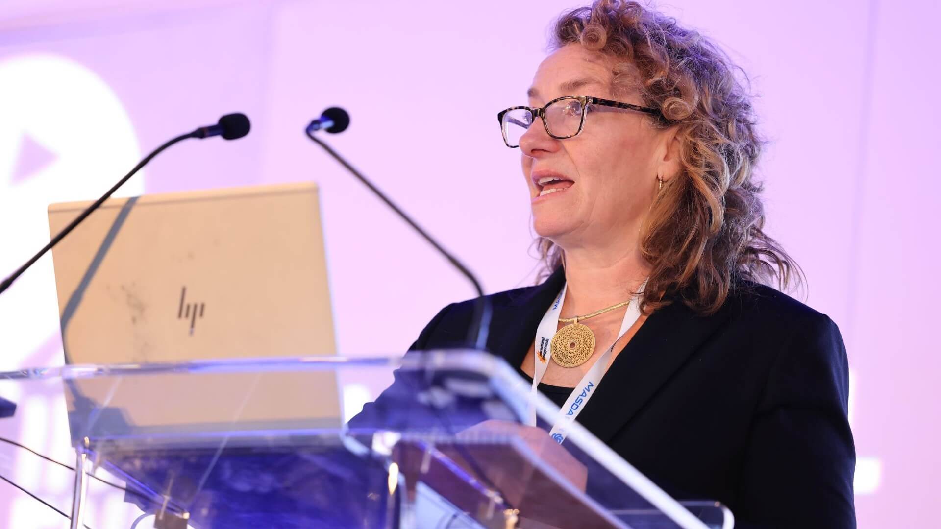 EI President Juliet Davenport at lecturn, speaking at International Energy Week 2024