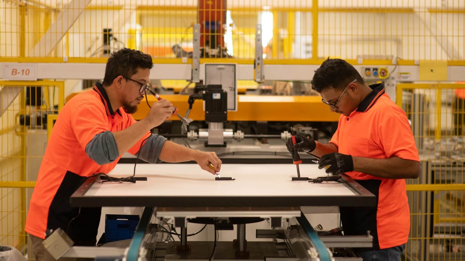 Operators working in solar panel factory