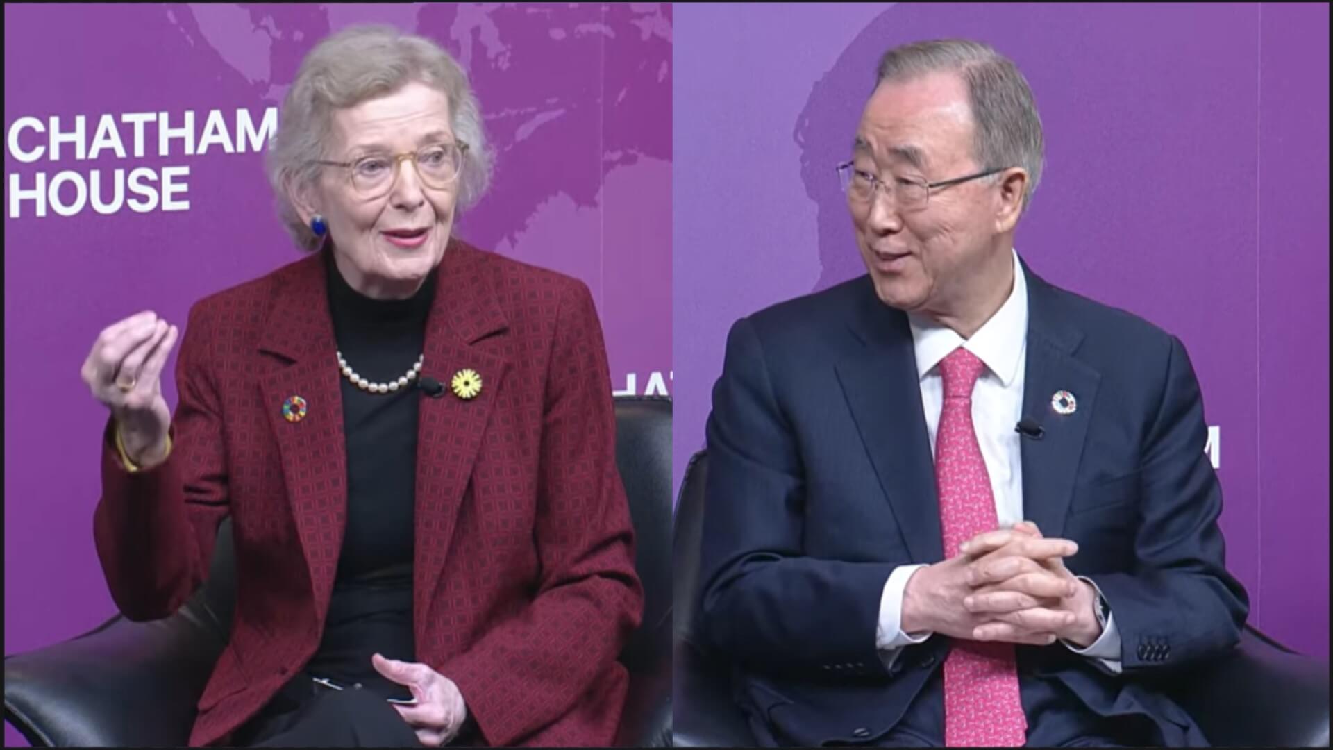 Close up of Mary Robinson and Ban Ki-moon sitting in chairs on stage, with Mary speaking and Ban looking on