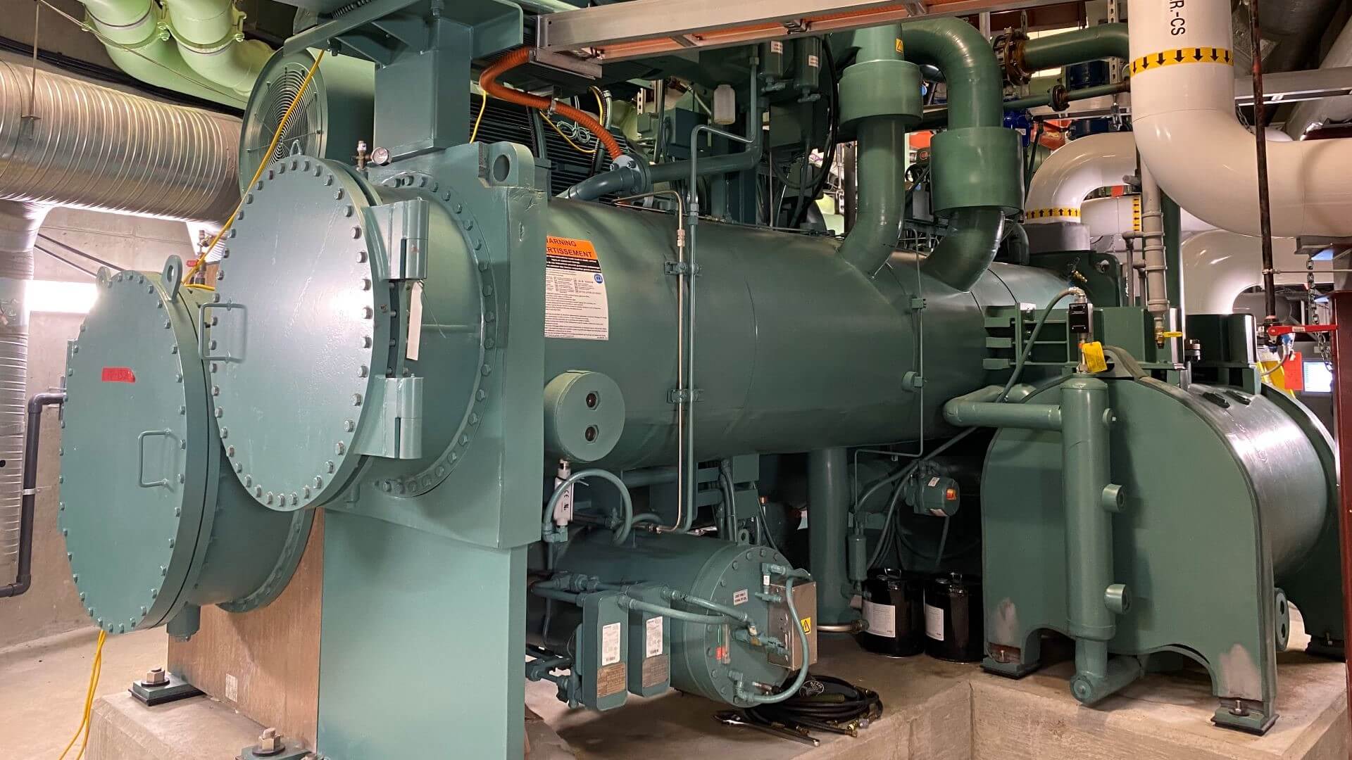 Close up of heat pump cylindrical tanks and pipework in equipment room