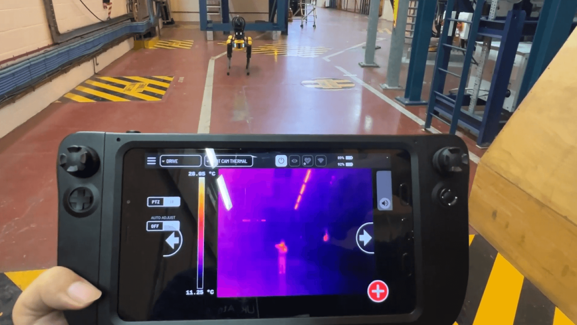 Hand holding the device showing robot's thermal imaging camera