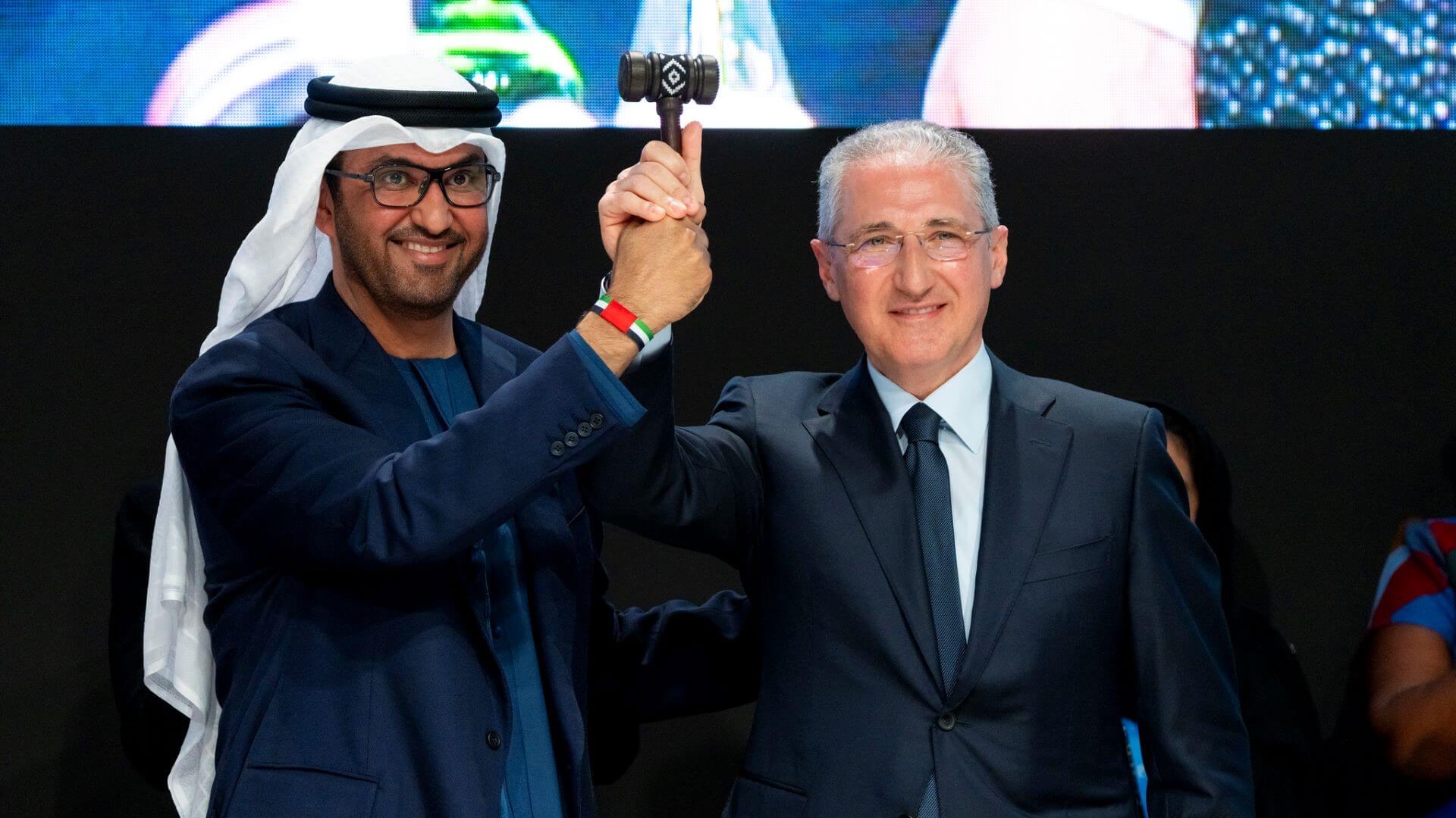 COP28 President Sultan Al Jaber (left) and COP29 President Mukhtar Babayev jointly holding a gavel and raising it in the air to open the COP29 conference